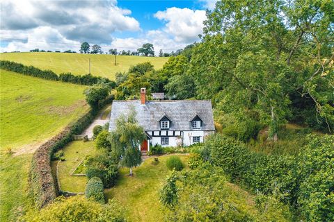 This enchanting 16th-century Grade II* listed detached cottage boasts three to four bedrooms and is brimming with character and charm. Nestled at the end of a lane on over a quarter of an acre, it offers sweeping views of the surrounding countryside....