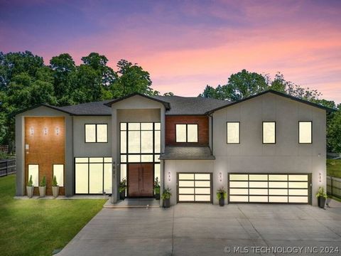 Discover modern luxury in this exquisite, privately gated home in Midtown Tulsa, set on a sprawling .77-acre lot. Designed by the renowned Atria Design Studios, this custom residence features a grand foyer with a crystal chandelier, marble floors, an...