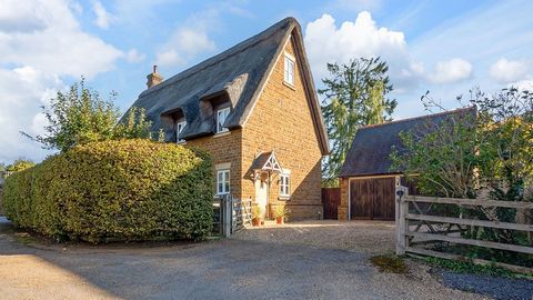 A beautifully presented detached thatched residence built from Hornton stone, to an award winning design, and in a sought after location, comprising entrance hall, cloakroom/WC, kitchen, utility room, dining room, superb sitting room, snug, four bedr...