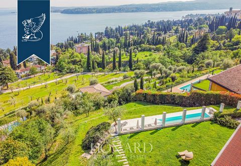 This luxurious modern villa with breathtaking views over Lake Garda is for sale in an exclusive hilly area in Gardone Riviera, just above Gabriele D'Annunzio's House-Museum, the famous 