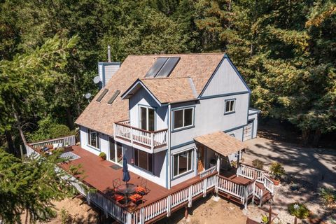Storybook setting in the redwoods on approx 8 acres. Enter via a long, private driveway, winding past majestic sequoias, to this secluded home site with inviting covered front porch, drought resistant landscaping, and spacious sunny deck. Charming in...