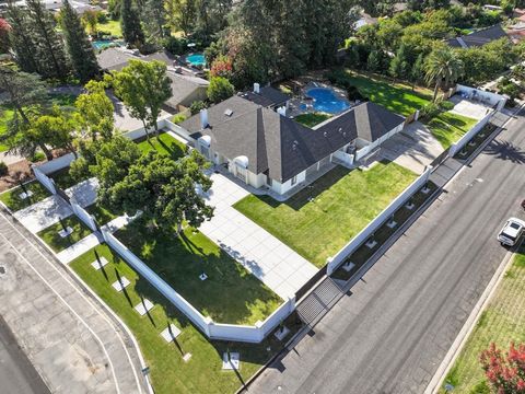 Magnificent Villa! Set on .75 Acres located on Fresno's most Prestigious Van Ness Blvd. This Mid Century Modern Masterpiece Exudes Elegance, Simplicity, Warmth & Beauty! 4 Private Electric Gated Entrances & a pedestrian gate. Be Impressed by the circ...