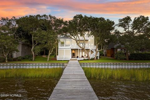 This custom built home is set perfectly under a majestic canopy of Live Oaks. Come experience the serenity of this home located on Bogue Sound. You will never want to leave. Once entering from the street, you will find a Suite on the first floor with...