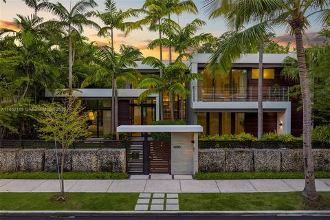 Indulge in the ultimate Coconut Grove lifestyle in this extraordinary modern estate by renowned architect Charles Treister. Perched atop a ridge 21 ft above sea level and surrounded by a lush garden, this unique Tri-Level home seamlessly blends indoo...