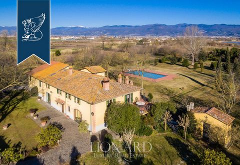 In Prato's countryside there is this lovely luxury property currently up for sale. This two-floored luxury villa enjoys a free sight on all its sides and has the typical looks of a Tuscan estate with red-bricked arches, wooden beams, stone stair...