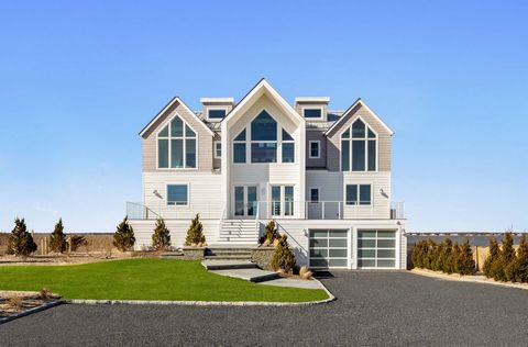 Transcending the notion of a mere home with an exquisite blend of timeless design and contemporary elegance, this newly constructed Nordic Modern Beach Home by First Dunes stands as a testament to coastal luxury living, offering a lifestyle of sereni...