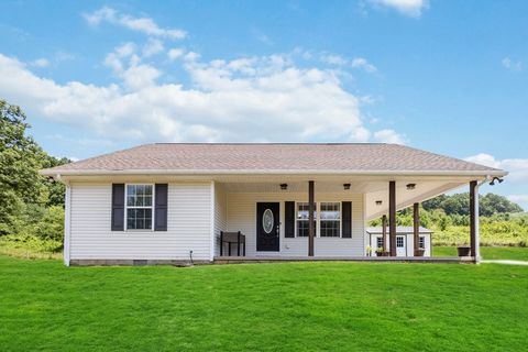 Don't miss this unforgettable gem! This 2050 sq. ft. modern farmhouse offers an open concept design with southern charm and stunning views from a wraparound porch. The property includes a cute matching storage shed and a detached 30 x 24 garage with ...