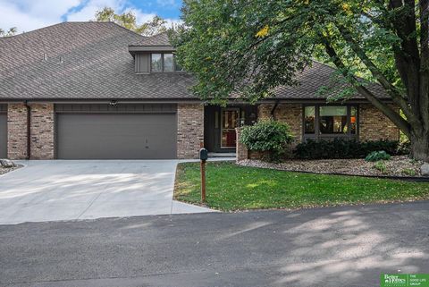 Nestled amidst lush greenery and mature trees, Brook Hollow offers a serene and private retreat for those seeking tranquility. The main floor boasts two spacious living areas, a formal dining room, a wet bar, vaulted ceilings, a fireplace, and a mode...