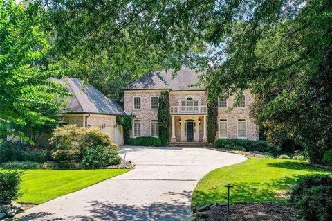 Situated within an exclusive cobblestone enclave in a sought-after Atlanta, locale, this luxury estate is the epitome of grand living boasting a remarkable five plus bedrooms and bathrooms. The sprawling primary suite on the main level is the sanctua...