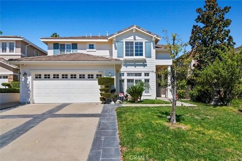 Popular Stevenson Ranch neighborhood. Title shows 3 bedrooms, Tandem garage was converted to 4th bedroom. Formal entry with step down formal living room with bevelled glass french doors. Large open family room and kitchen with remodeled granite cente...