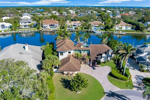 149ft of sea-walled water frontage! Spacious 5-bedroom, 4.5-bathroom estate in the prestigious gated community of The Moorings. Expansive open-concept living area with soaring ceilings, and natural light flowing throughout. Large remodeled gourmet ki...