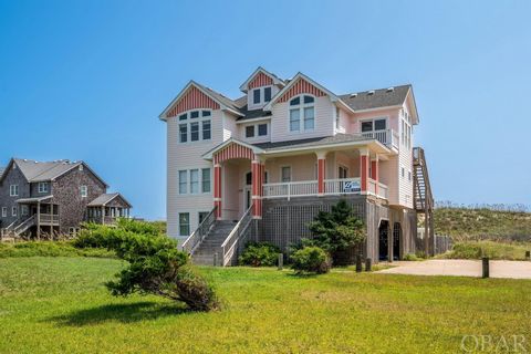 This awesome and unique home generated over $176,000 in owner revenue and is situated back from the established protective dune on the largest oceanfront lot around. The back-breaking work has been done already by respected builder Arch Morse. The ex...