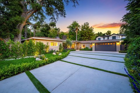 Tucked behind a private gate on a secluded tree-lined street south of Ventura Blvd., almost half an acre of beautifully landscaped grounds envelope this stunning single-level contemporary residence that exudes serenity and is a showcase for the allur...