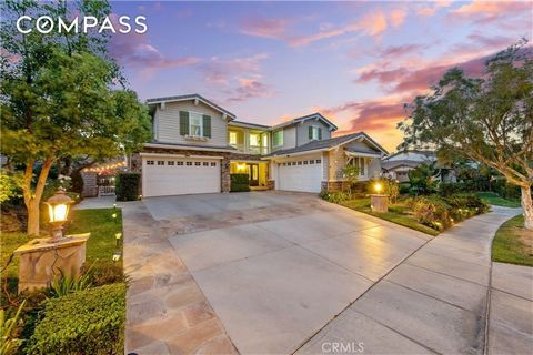 Welcome to the epitome of luxurious living in the exclusive gated community of Sierra Peak, nestled at the base of the majestic Santa Ana Mountains next to Yorba Linda. Highlighted by a massive entertainer's backyard featuring a rock saltwater pool a...