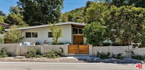 A picturesque mid-century mountain cabin, nestled within the pastoral beauty of Mandeville Canyon, this 3 bedroom/2 bath 2,112 sq ft home is peaceful canyon living mere moments north of Sunset. Designed by famed architect Allen Siple and situated on ...