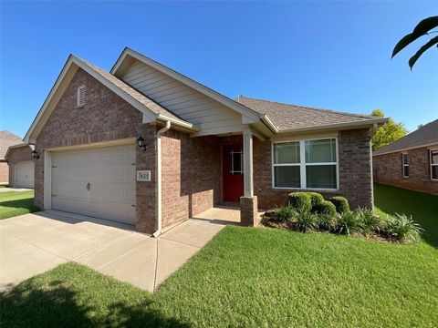 Yukon's The Springs at Settlers Ridge addition! Living room features laminate flooring with ceiling fan. Kitchen features vinyl flooring, pantry, and dining area, equipped with refrigerator (as is), microwave, disposal, dishwasher, and gas cooktop! P...