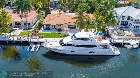 Gated and walled Coral Isles Spanish Colonial-inspired Deepwater estate sited on 100 +/- feet of waterfrontage in exclusive Las Olas Isles. Private canopy treed courtyard entry greets guest to an glass enclosed lanai. Formal Living/Dining Room and Cl...