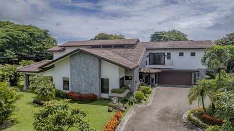 Highlights -Elegant 5-bedroom residence with a sprawling 3,600 m² lot and 600 m² of construction. -Perfect fusion of transitional colonial charm and contemporary luxury with warm wooden accents and high ceilings. -Expansive outdoor area featuring a h...