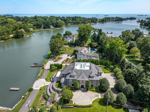 Exclusive, gated Indian Harbor Association with 24-hour security showcases an elegant waterfront home set atop manicured .85 acre with private dock, verandas and potential pool site. This 2015 custom built home is nothing short of perfection with gre...