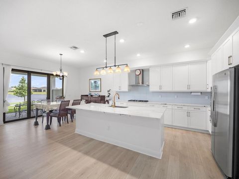 Experience elegant living in this contemporary spec home, nestled within the prestigious 55+ community of Cresswind Palm Beach. Crafted by Kolter Homes in 2022, this residence offers lake views and an expanded primary bedroom for added comfort. The i...