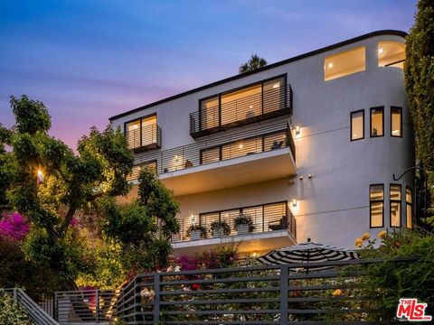 Uniquely situated on a serene and wide, tree-lined street in the West Hollywood hills, this modern oasis has expansive views, yet is only 60 seconds above the iconic Sunset Strip. In 4,000 square feet, the floor plan is thoughtfully configured and co...