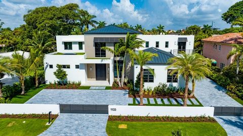 This masterful new estate, in Boca Raton's prestigious Estate Section, features ultra-chic architect-designed Farmhouse Modern styling with an open floor plan, split-bedroom layout. Details include expansive interiors, volume ceilings, and walls of g...