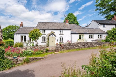An attractive Welsh Cottage believed to date from the 1800s with contemporary addition, including a delightful glass walled garden room. The house is complemented by beautiful, mature gardens including woodland and detached building which is ideal fo...