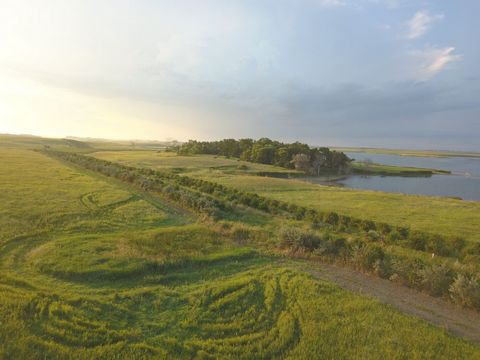 Nestled in the heart of South Dakota's Glacial Lakes Region, Hidden Hill Lodge is a 316-acre turnkey sportsman's paradise. This breathtaking property features a modern 13-bedroom, 7.5-bath lodge that offers stunning views of a private access lake and...