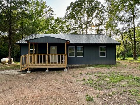 Stunning 40 +/- acre on HWY 39 only 12 miles from Shell Knob and Cape Fair! The Hidden 40 has a custom built 1200 sq ft home, completed in Spring 2024 and has 2nd electric and 2nd septic hookup for trailer or RV! This tract has a gorgeous pond and ce...