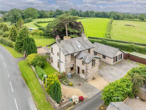 An attractive central staircase hall opens to a living kitchen running front to back, separate sitting and dining rooms, a useful utility room and a large conservatory. Rising to the first floor and there are four double bedrooms and a house bathroom...