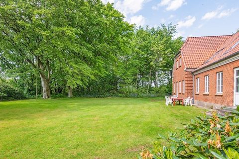 This large and well-appointed cottage is the former village school in Staby. The holiday home, which is designed for 20 people, is located calmly and peacefully with a view of fields to one side - and to the other offers a courtyard and a large natur...