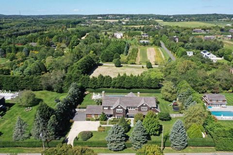 Situated on a quiet cul de sac in Bridgehampton, this traditional is the quintessential Hamptons home, combining elegant design with a modern flair. The first floor of this 8,200 +/- sq ft residence is entered through a beautiful foyer leading to a g...