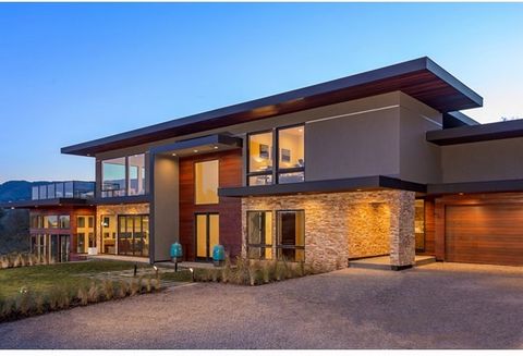 New contemporary home with breathtaking views designed by award-winning M Designs Architects. Stacked stone and cedar define the sleek modern lines of the exterior. Spacious living/dining room combination spans the depth of the home overlooking the f...