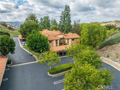 This corner unit in The Hills community of Yorba Linda offers a delightful blend of privacy and scenic views. With three bedrooms, a master bathroom, and a walk-in closet, the tastefully renovated property with too many items to list features a beaut...