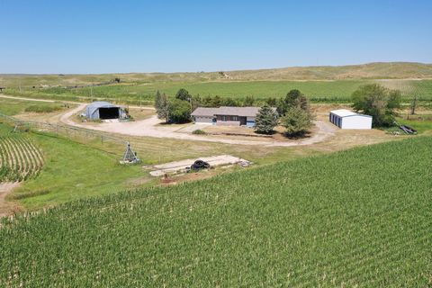 Tract 1 Becker Scottsbluff County Farm features a nice ranch style home with 3 bedrooms, 2.5 bathrooms and a nice large living area off the kitchen and dining room. There is a 75 +/- acre wiper pivot and an additional 70+/- acres of flood irrigated c...