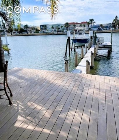 Welcome to Coquina Cove, a 55+ coastal hidden gem where **you OWN the land**—no lot rent here! This rare opportunity offers direct **waterfront living on the Intracoastal Waterway in Indian Rocks Beach** with your very own **private dock and boat lif...