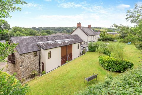 Main House Facing is the converted barn that provides the holiday cottages whilst the main house sits off to the left behind a low hedgerow and a picket gate begins the journey to the front door, although a wrought iron gate takes you in under an arc...